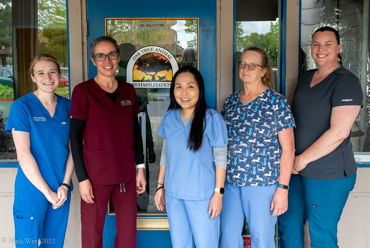 Several Staff Members posing in front of the office door